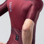 Gobik Magnitude short sleeve cycling jersey in burgundy Barossa colorway on male cyclist