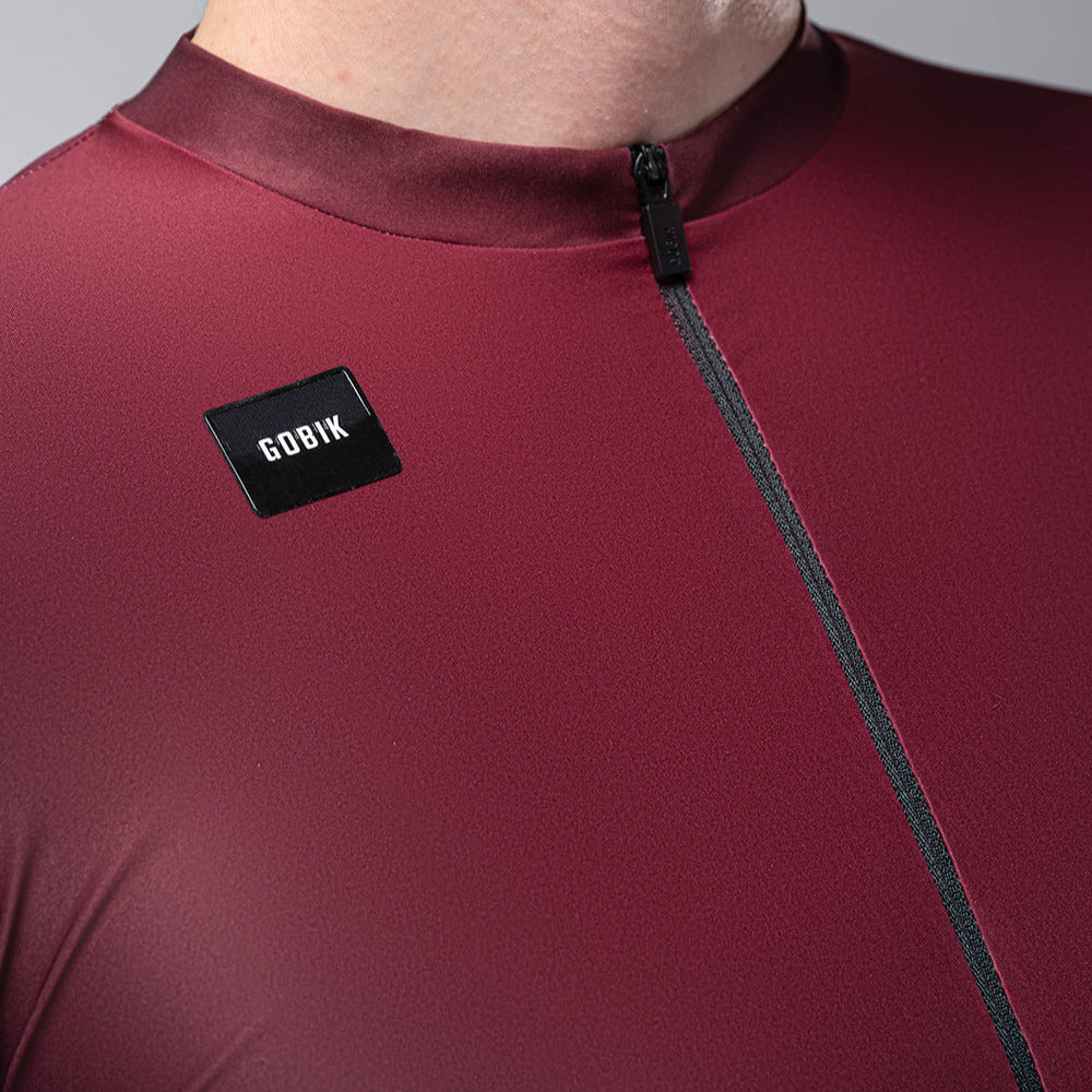 Gobik Magnitude men's cycling jersey in burgundy with black label and zipper detail