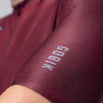 Close-up of Gobik Magnitude jersey sleeve in burgundy Barossa color showing textured fabric detail