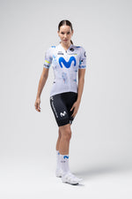 Professional cyclist wearing white Gobik Odyssey jersey with Movistar team branding and black shorts