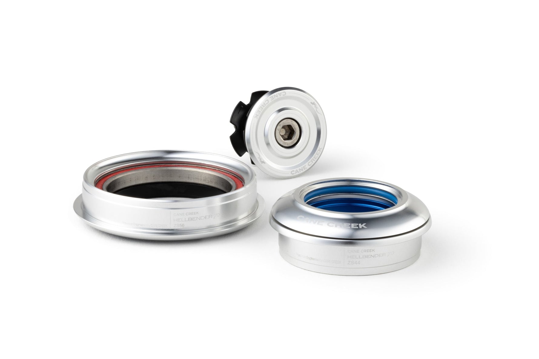 Cane Creek headset components with silver finish and colored bearing seals on white background