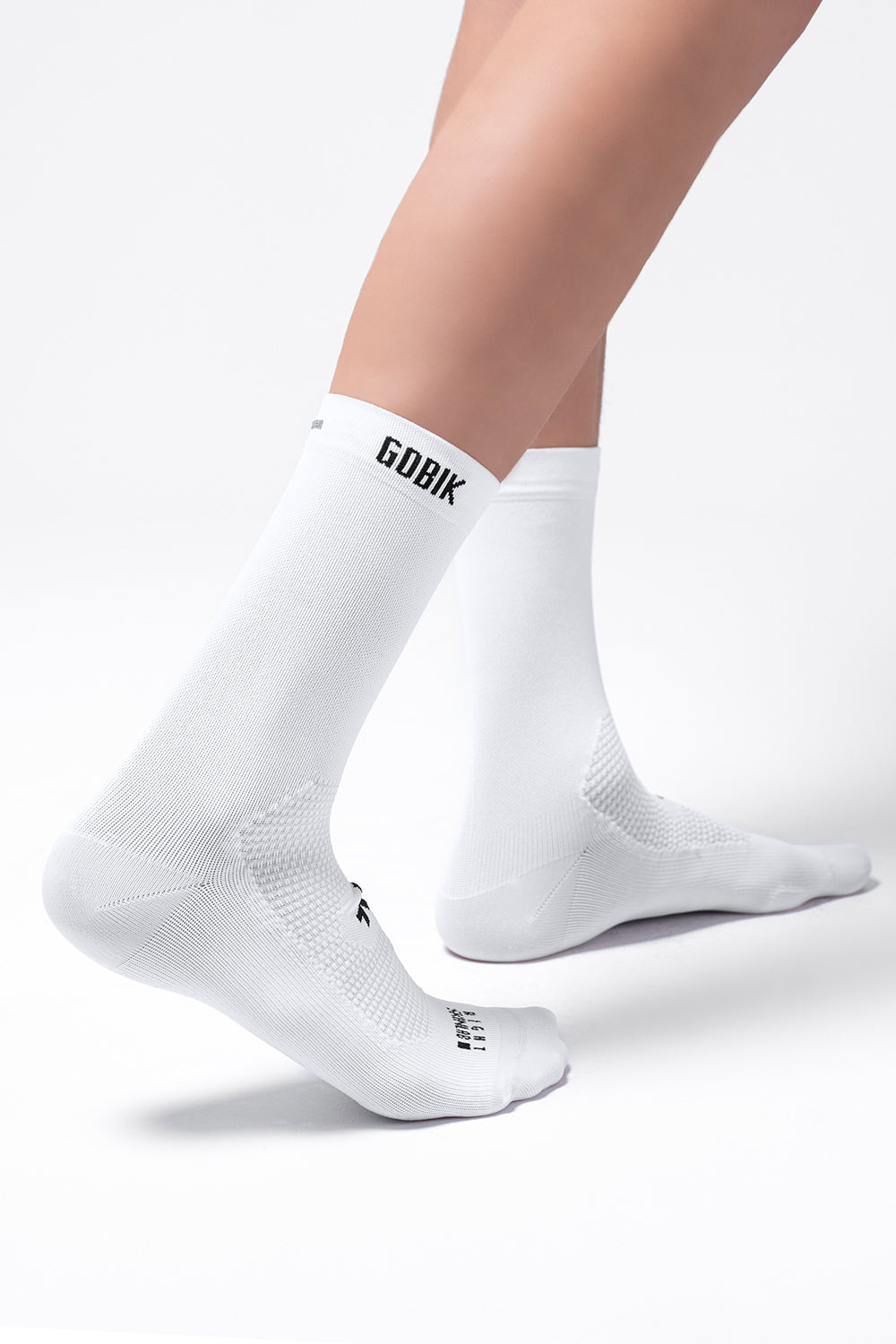 White Gobik Icon unisex cycling socks on model legs against clean background