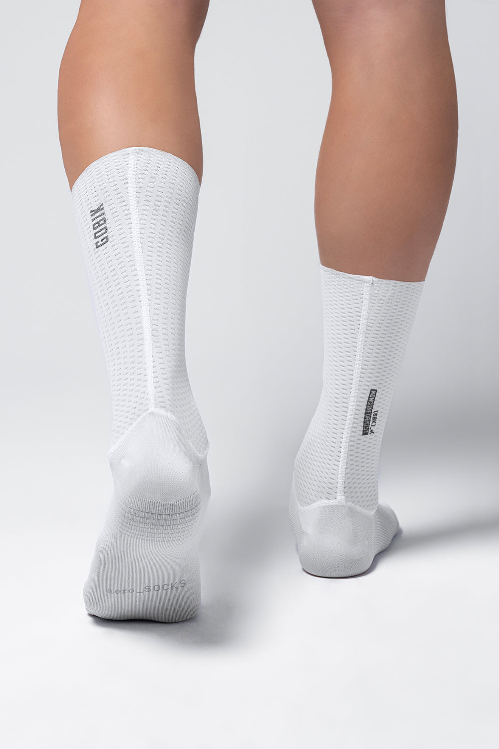 White Gobik Vortex cycling socks with mesh ventilation zones worn on legs