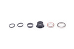 Specialized headset components including black spacers, cone cover and silver bearings on white background