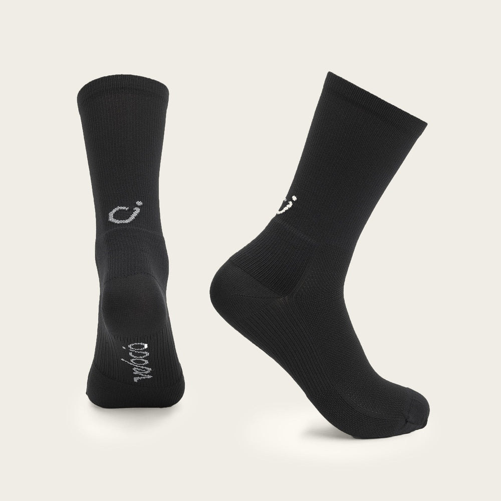 Black Velocio cycling socks with white logo branding on clean studio background