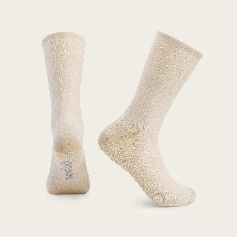 Velocio cream colored ultralight crew socks on clean studio background