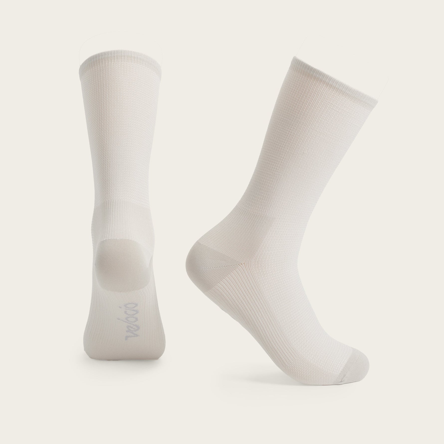 Two Velocio ultralight cycling socks in pearl grey color on neutral background