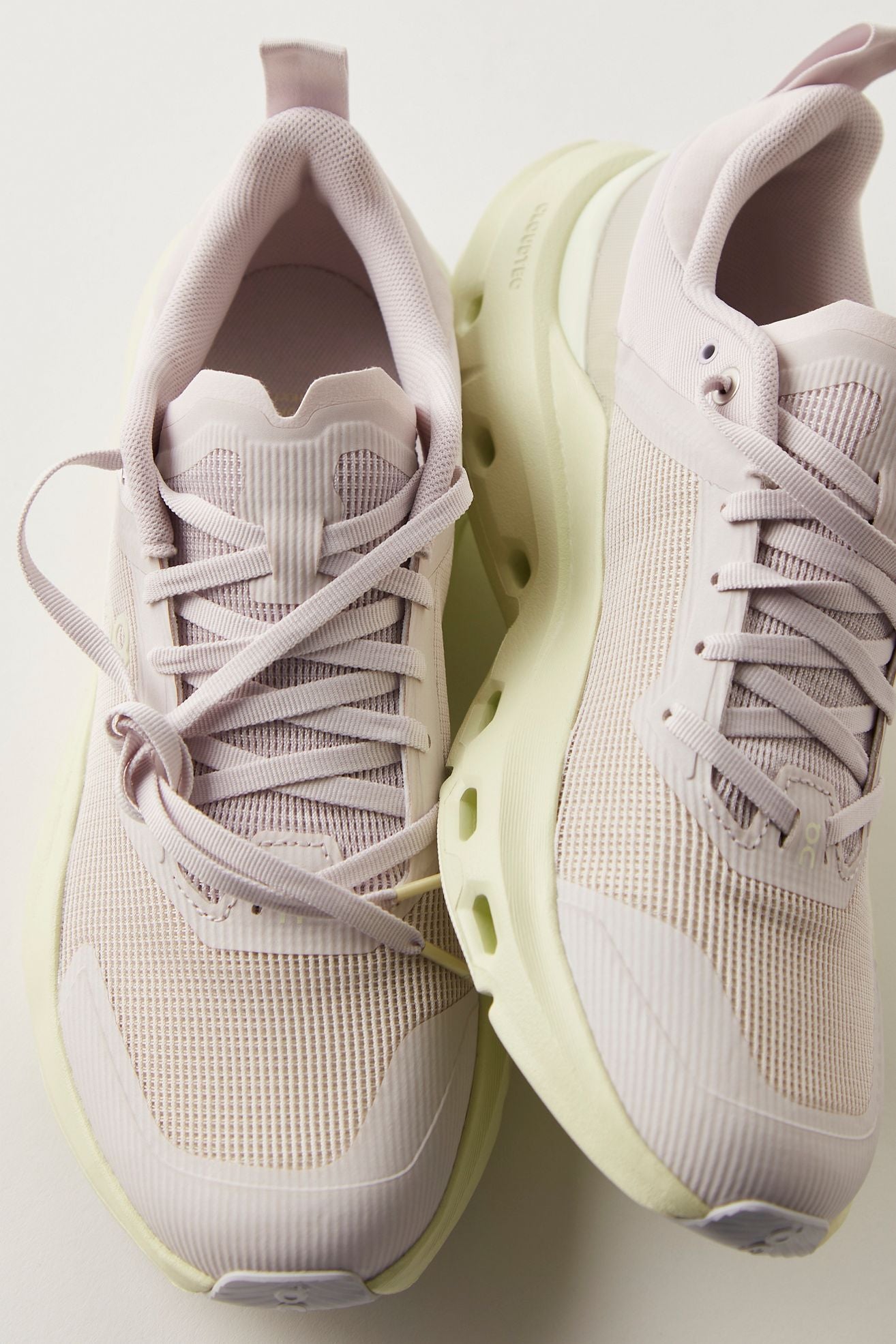 On Cloudpulse Next women's running shoes in light pink with honeydew sole detail