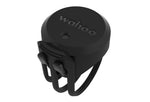 Black Wahoo speed sensor with silicone mounting strap on white background
